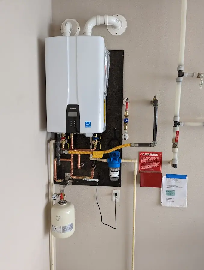 Professional plumber installing copper piping in a South Houston home